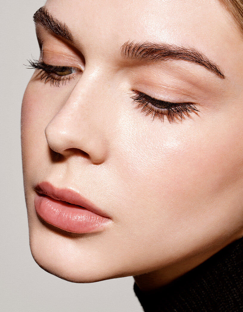 model with lashes and brows looking down