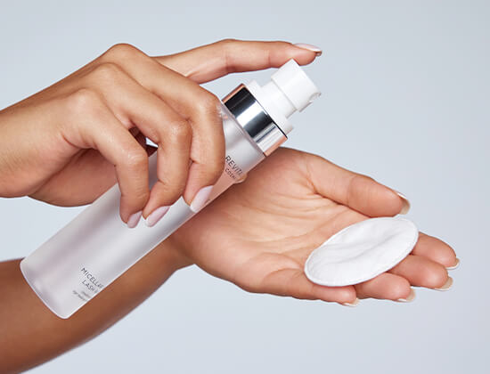 model spraying micellar water lash wash on cotton pad